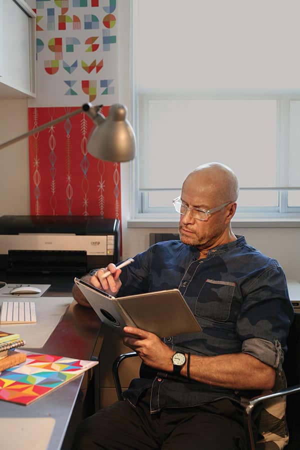 Photograph of educator Thom Sevalrud sketching on his tablet