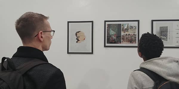 People viewing gold medal winning pieces